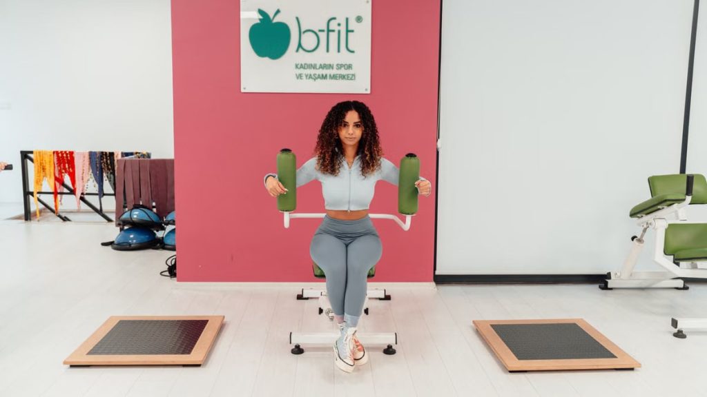 A woman exercising at B-Fit gym in Yalova, Türkiye, focused on fitness and health.